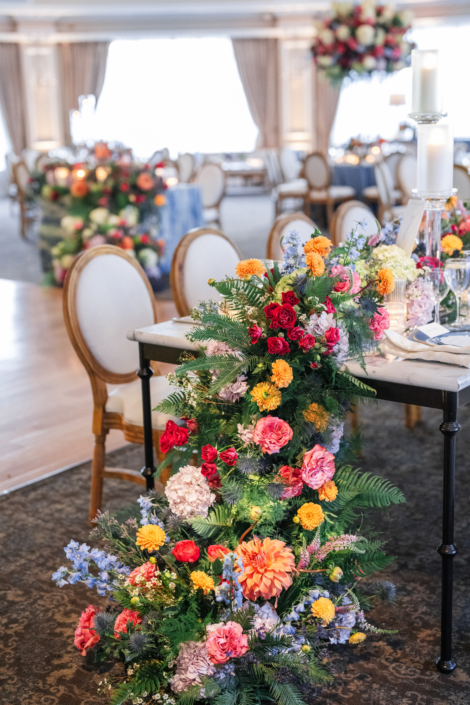 A table decorated with a vibrant floral arrangement featuring