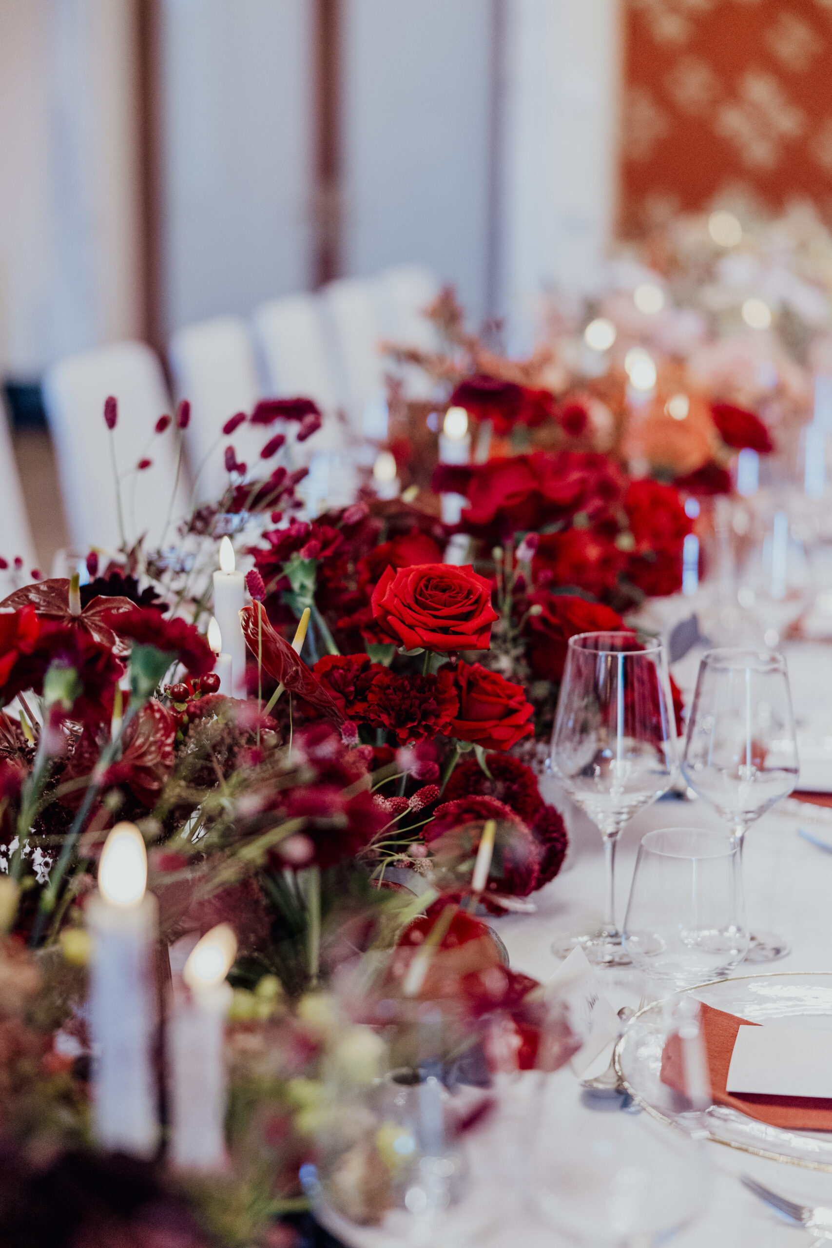 Elegant table setting with red roses and assorted flowers as a ...
