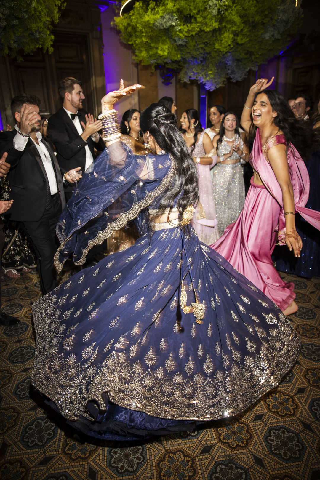 A woman in a blue ornate dress twirls joyfully on the dance floor at a Lake A woman in a blue ornate dress twirls joyfully on the dance floor at a Lake