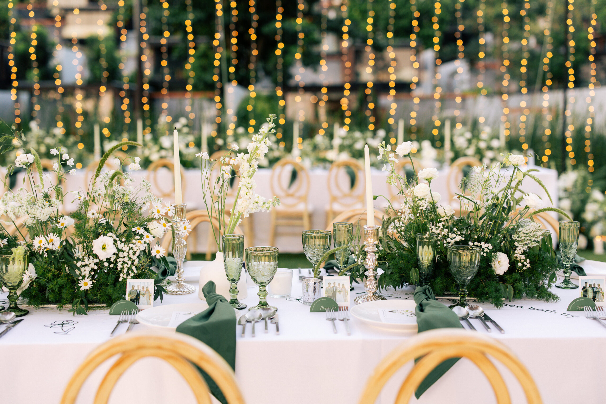Elegant outdoor dinner table setup with white linens, green napkins ...