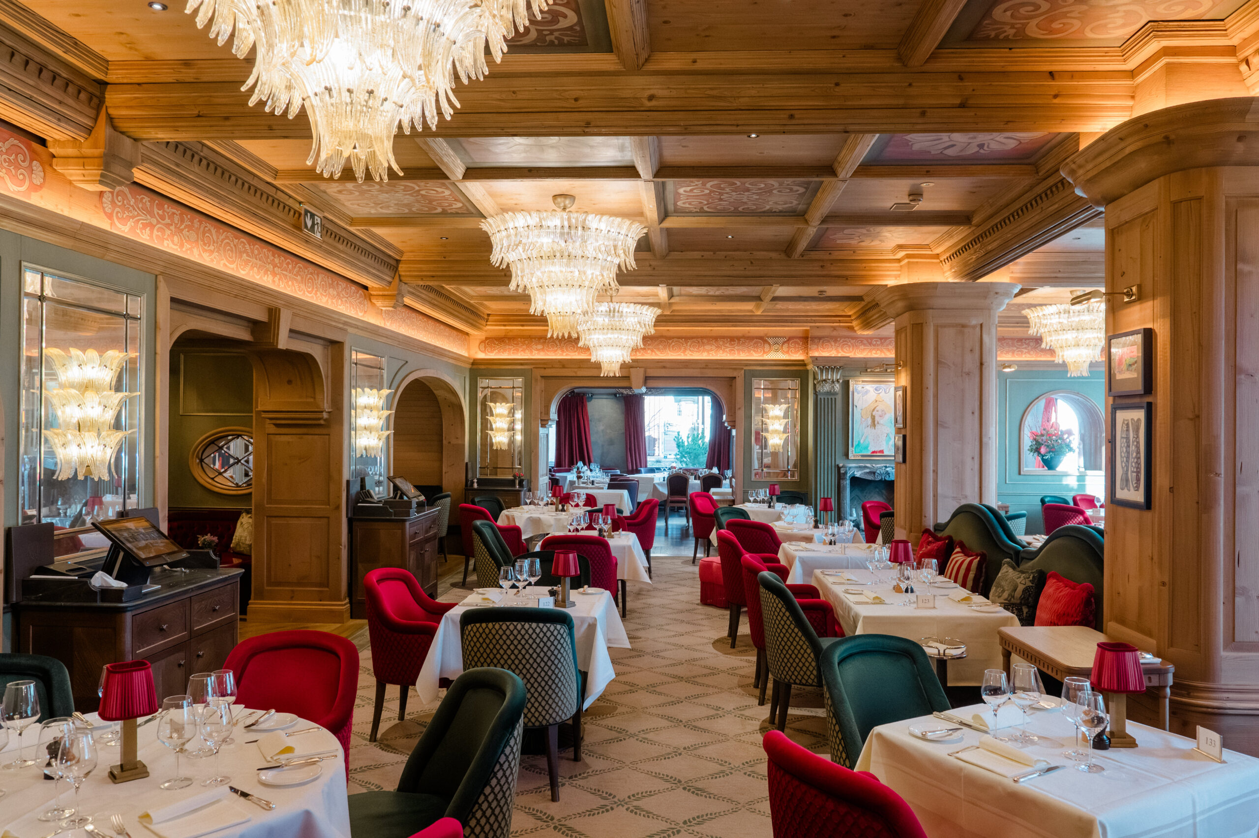 Elegant restaurant interior with chandeliers, wooden ceiling, and ...