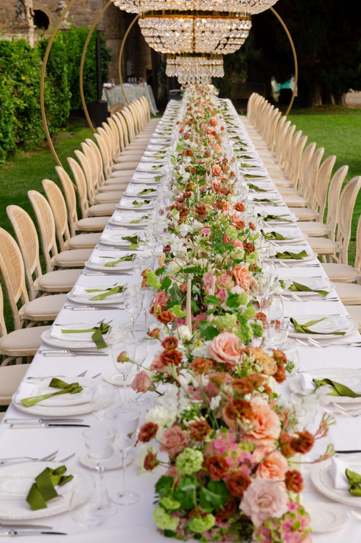 A wedding ceremony setup creates a pink rose wonderland, featuring 