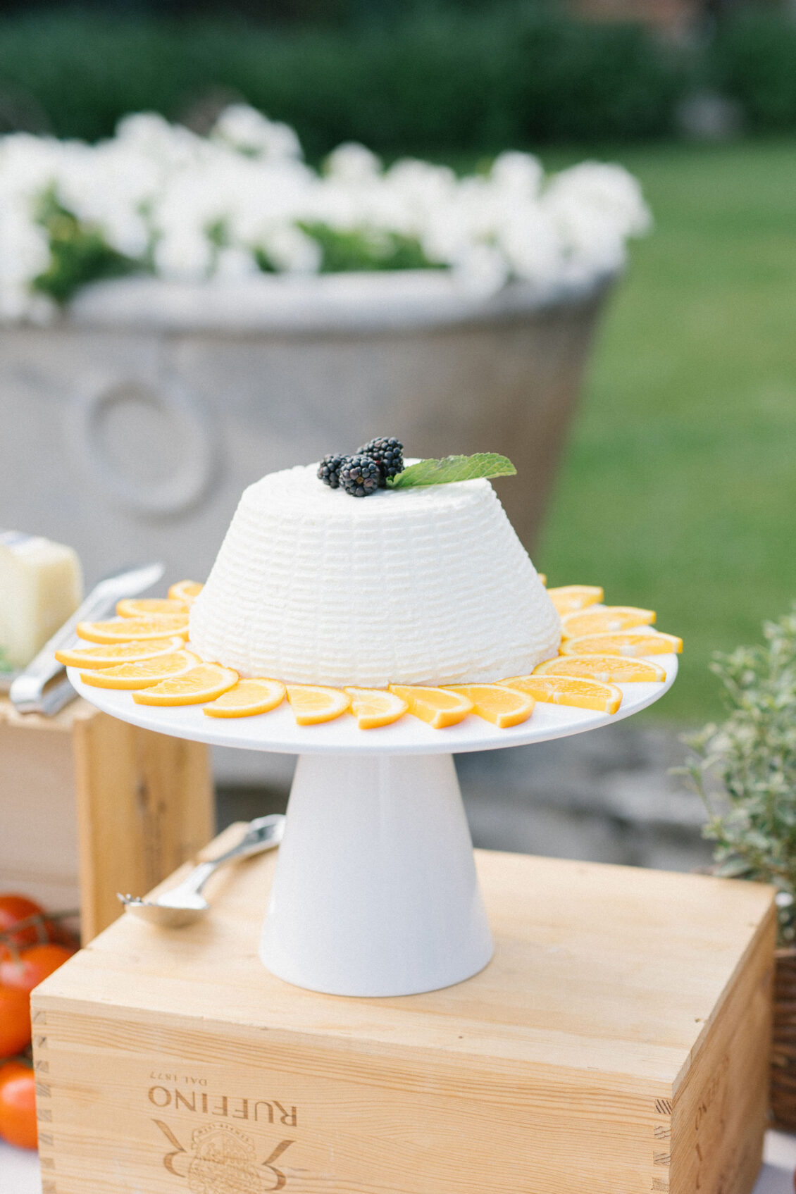 White citrus-ringed cake topped with a blackberry and mint at the Villa Pazzi wedding