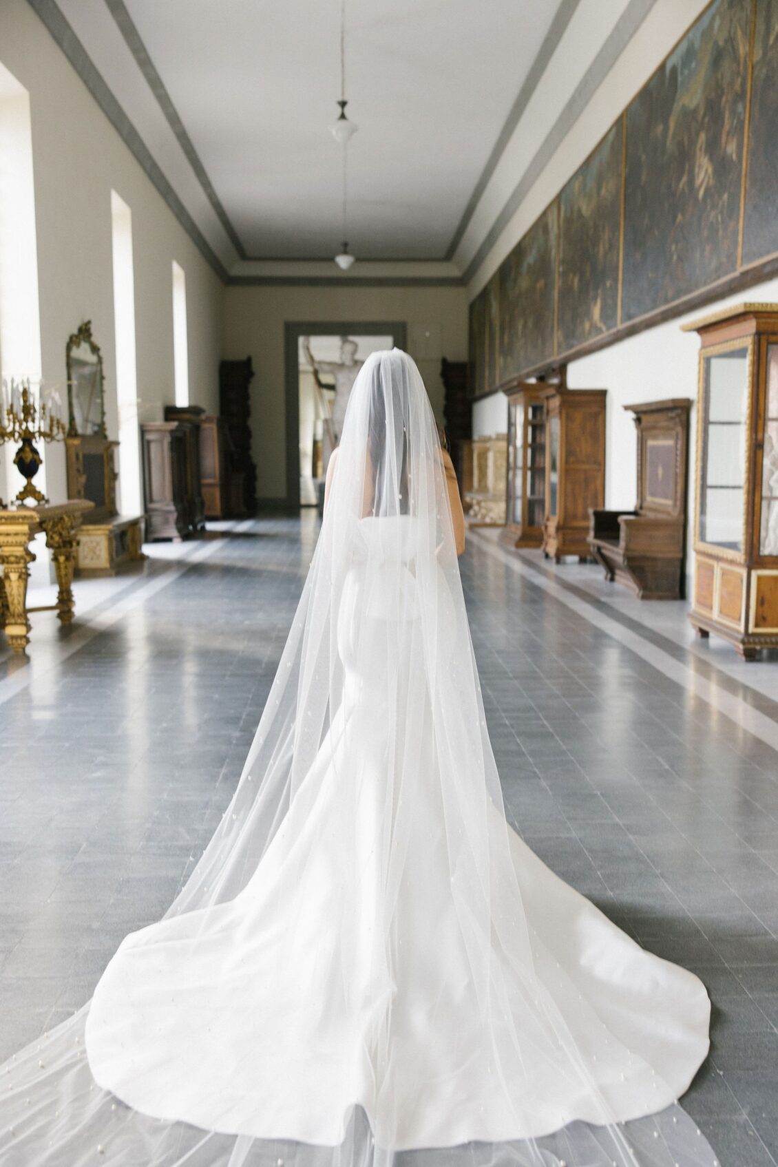 Jennifer showing the pearl-detailed veil and train inside the Tuscan villa
