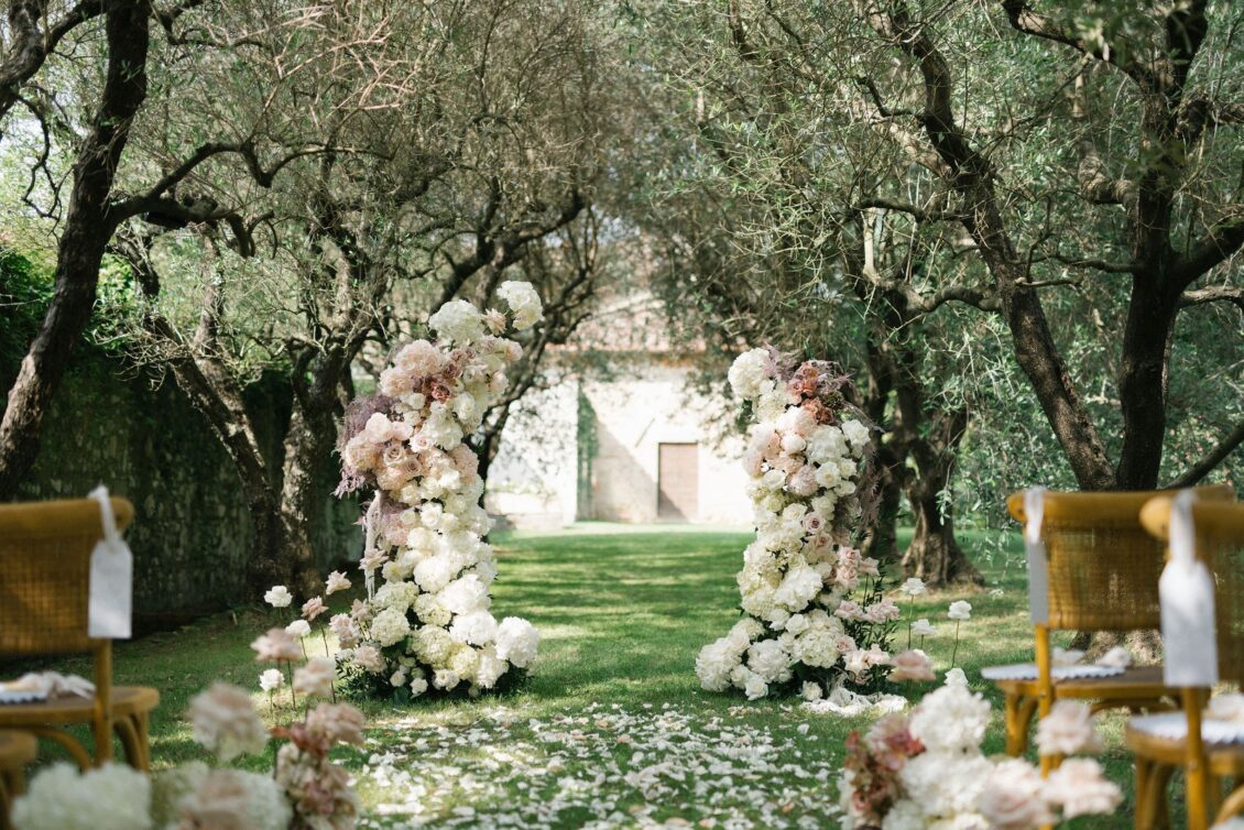 Olive-grove wedding aisle and floral arch at Villa Pazzi al Parugiano