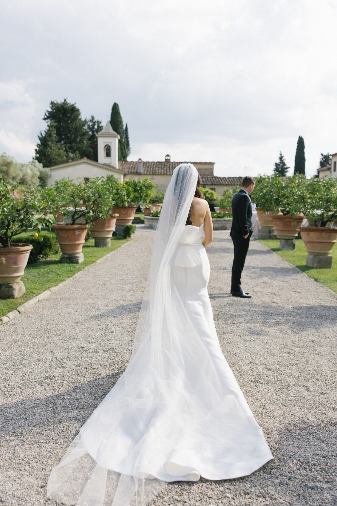 Jennifer approaching Travis in the Italian garden before the ceremony