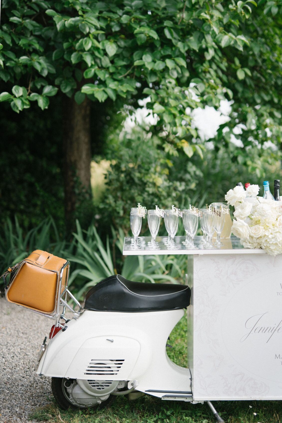Vintage white Vespa and wedding welcome display in Tuscany