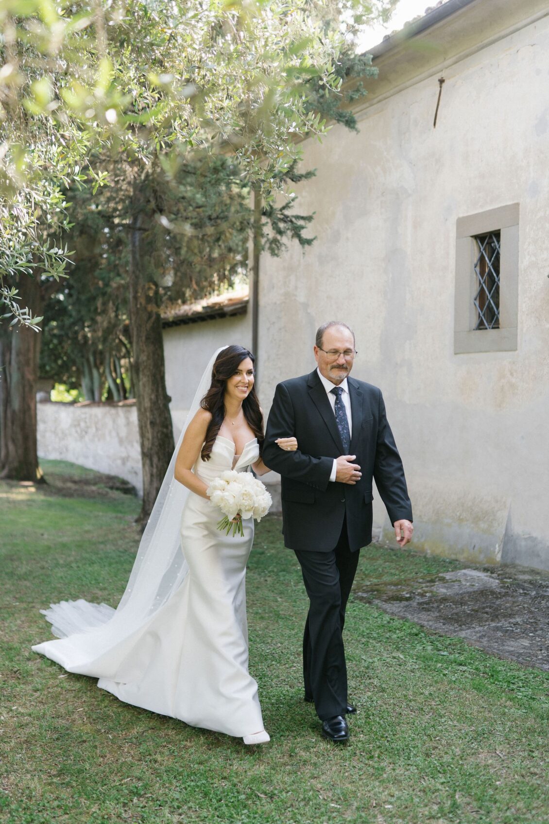 Jennifer walking to the olive-grove ceremony with her father
