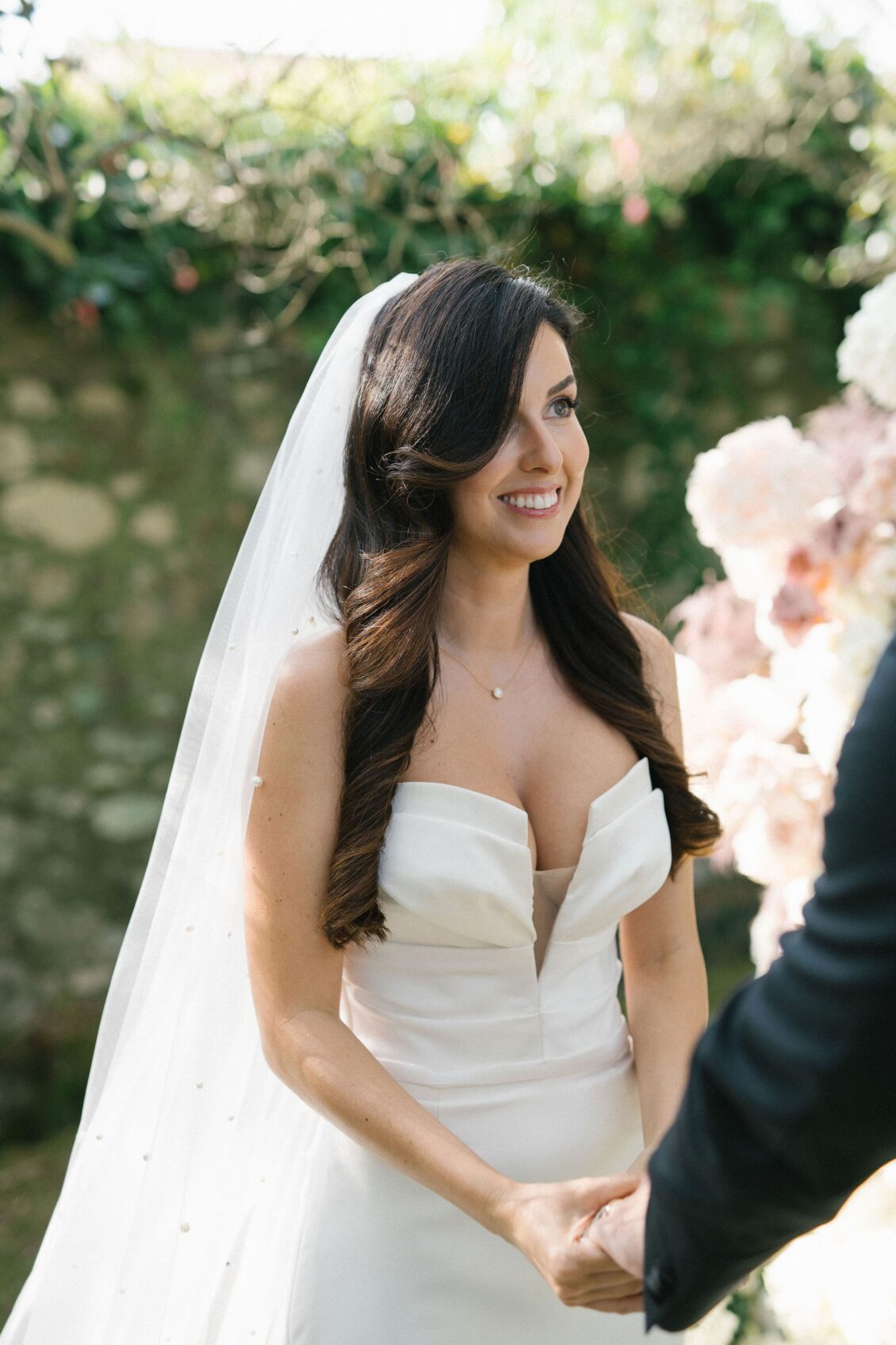 Jennifer smiling at Travis during their outdoor Tuscany ceremony