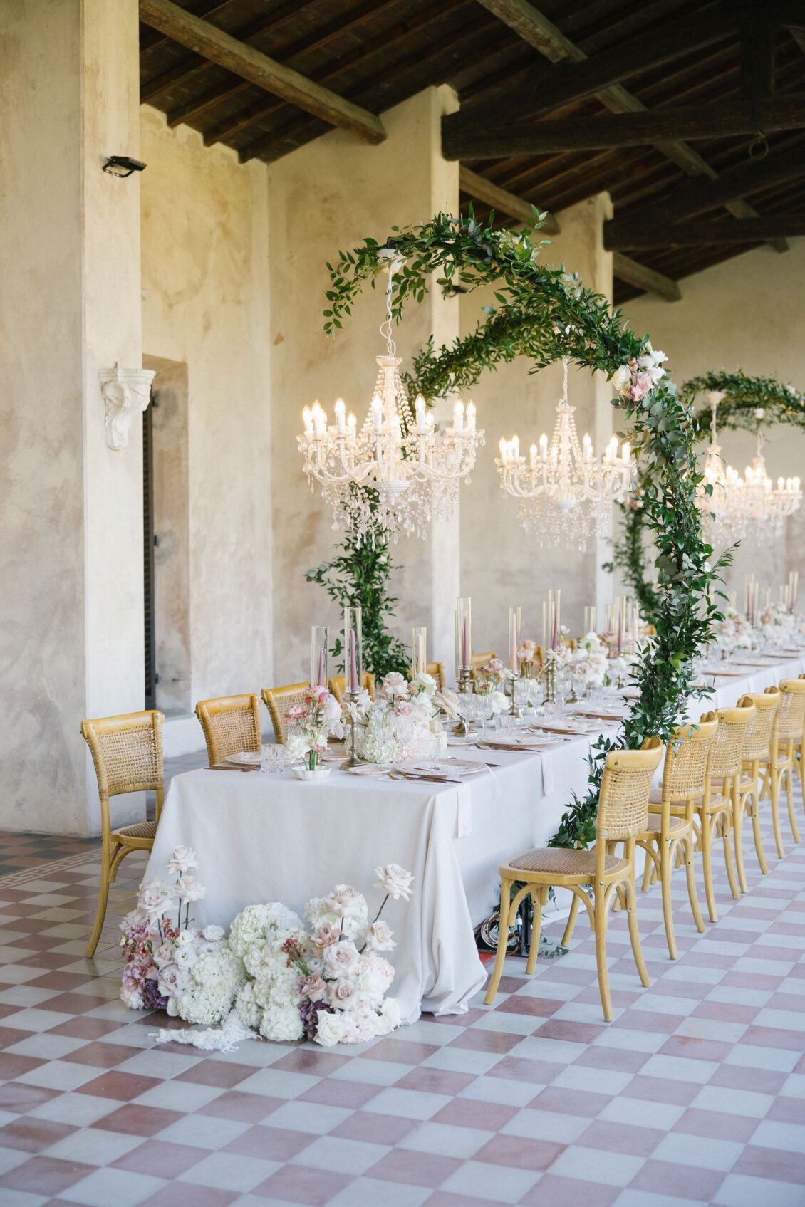 Floral reception table and chandeliers in the Tuscan villa altana