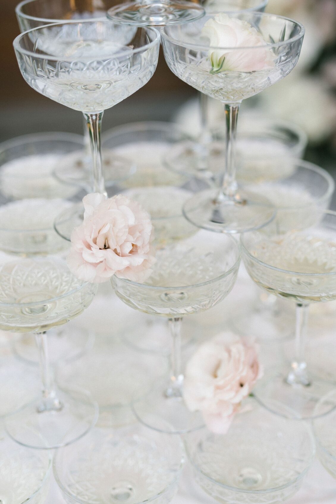 Champagne coupes decorated with pale blush roses