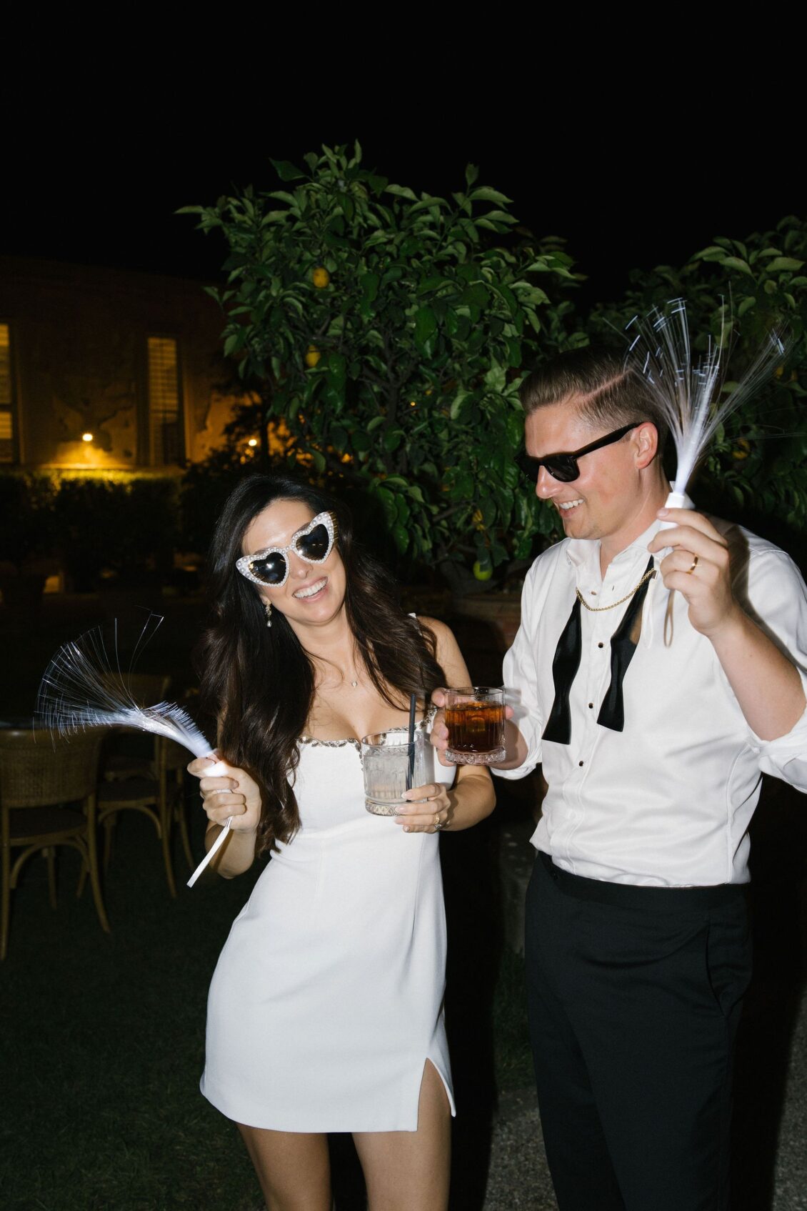Jennifer and Travis celebrating together in their second-look party outfits