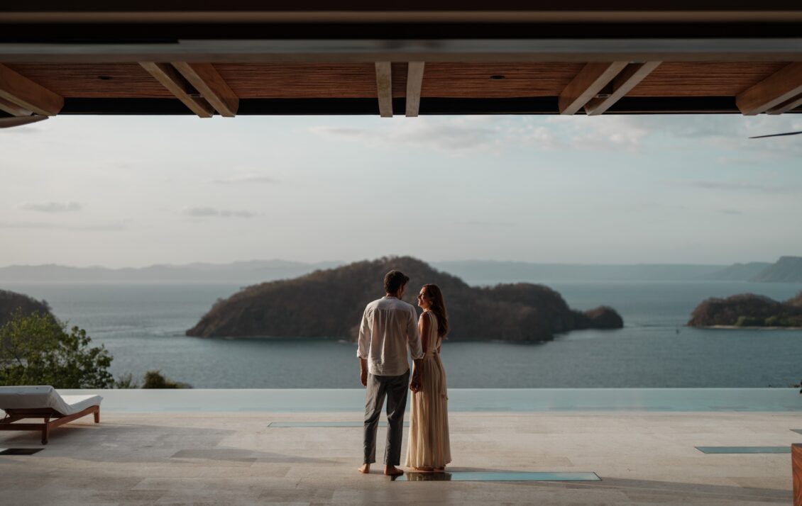 A couple overlooks the Pacific Ocean from an open-air terrace at Nekajui.