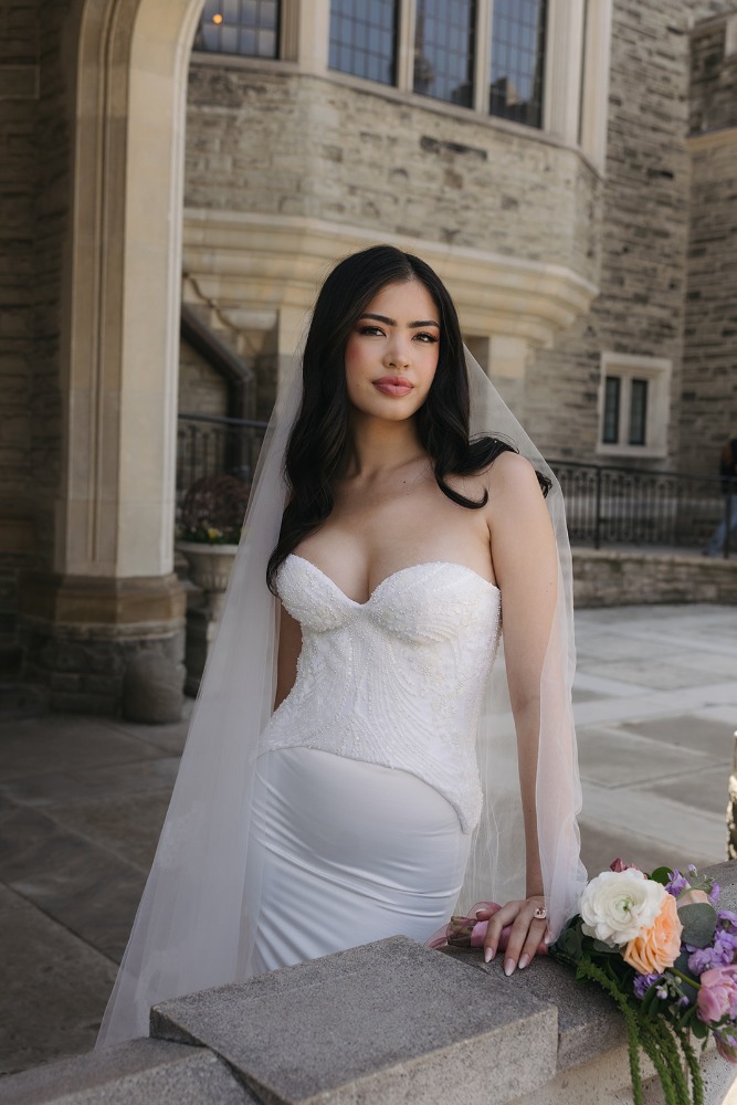 Bride posed at a stone balustrade