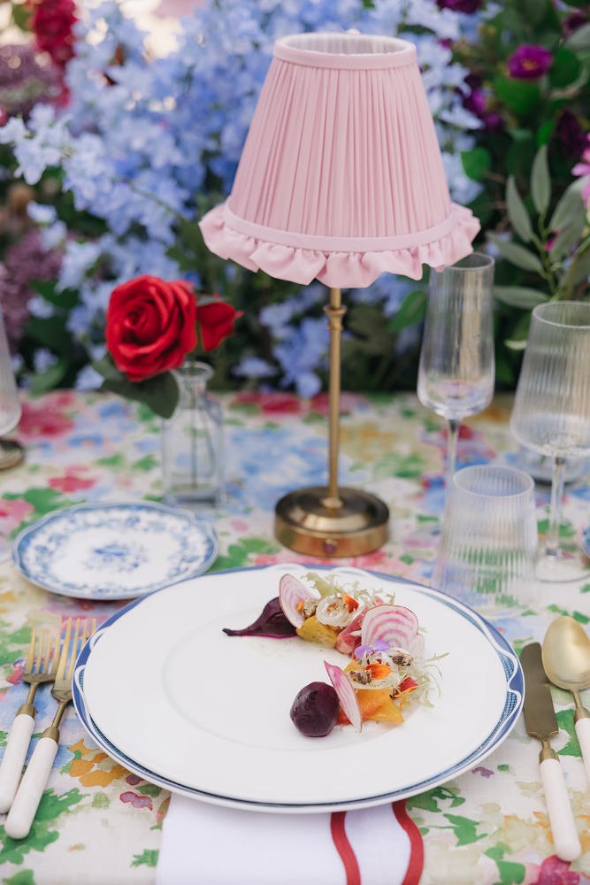 Plated dessert with florals and a pink table lamp