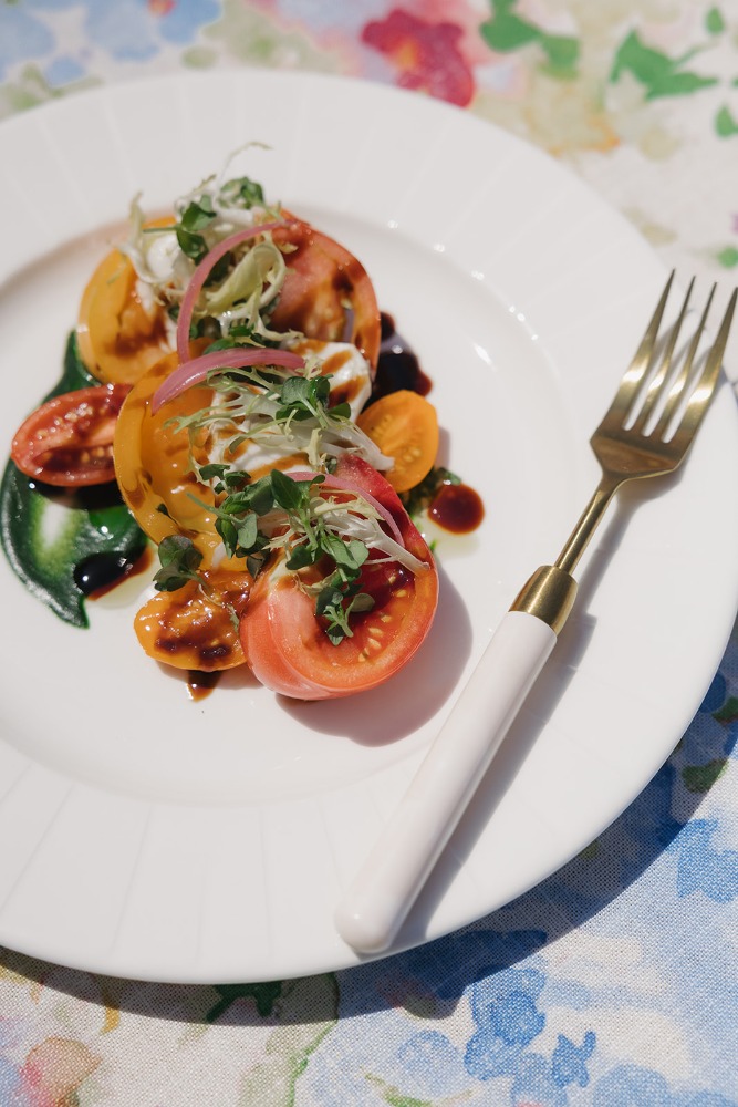 Colourful plated course with gold flatware