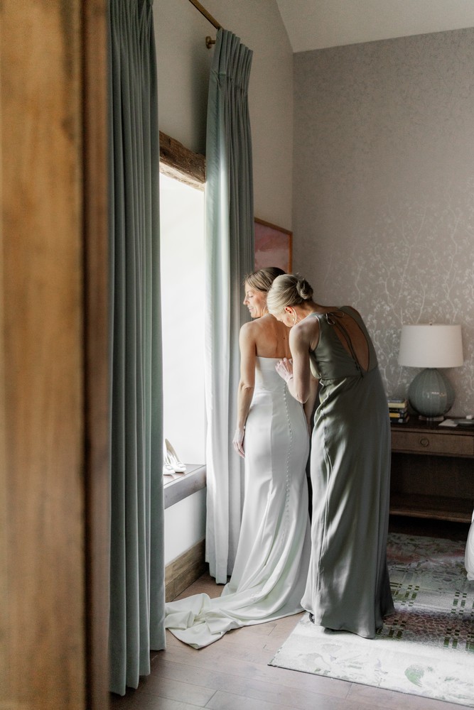 Marta and Eric at Elora Mill — bride getting ready window — photographed by Rose Vine Studios