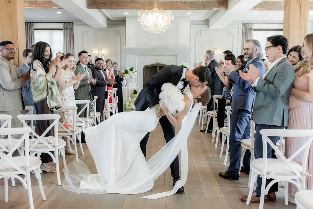 Marta and Eric at Elora Mill — recessional dip kiss — photographed by Rose Vine Studios