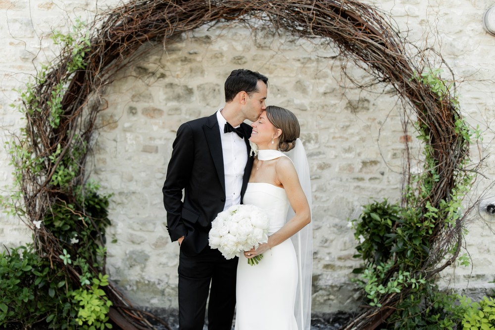 Marta and Eric at Elora Mill — couple vine arch portrait — photographed by Rose Vine Studios