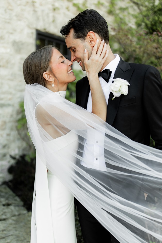 Marta and Eric at Elora Mill — couple windblown veil portrait — photographed by Rose Vine Studios