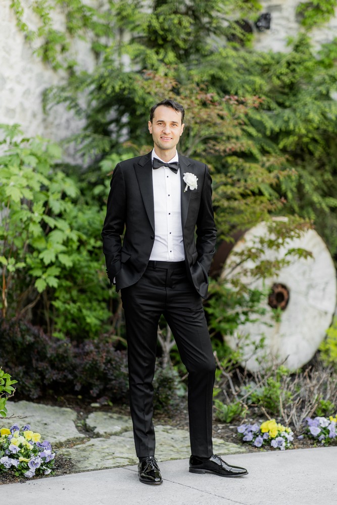 Marta and Eric at Elora Mill — groom garden portrait — photographed by Rose Vine Studios