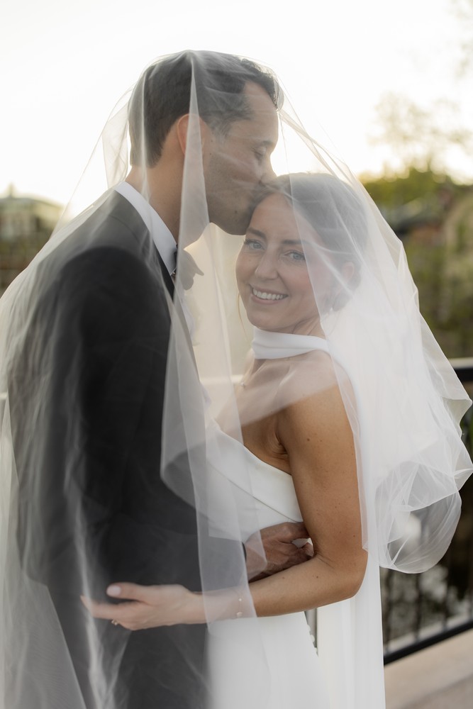 Marta and Eric at Elora Mill — couple under veil portrait — photographed by Rose Vine Studios
