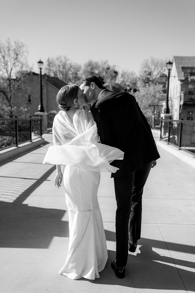 Marta and Eric at Elora Mill — couple bridge kiss — photographed by Rose Vine Studios
