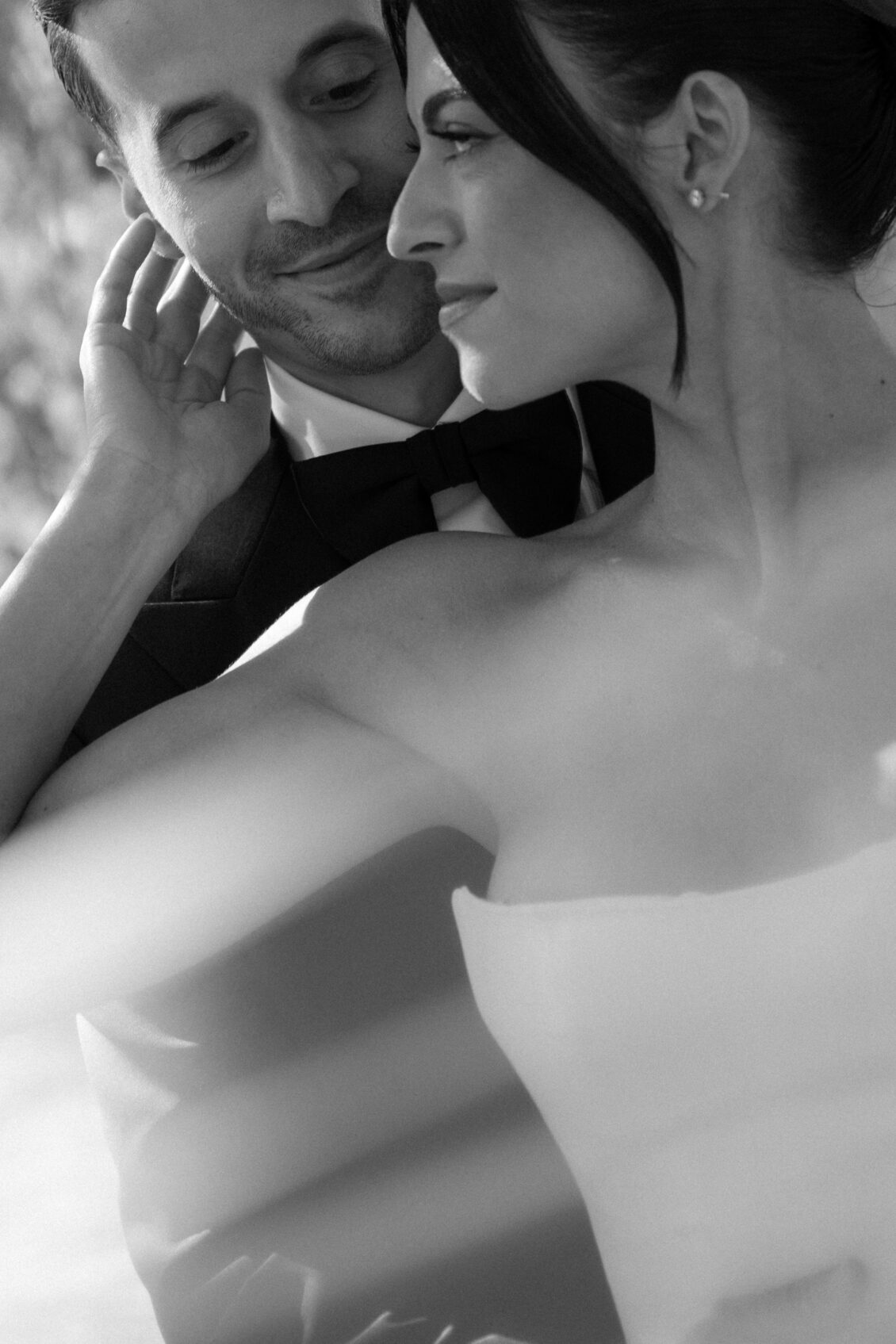A black-and-white portrait of Erica and Anthony outdoors.