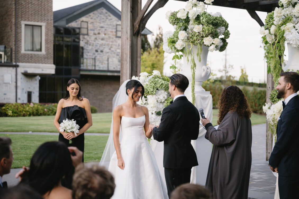 Erica and Anthony exchange vows outdoors.