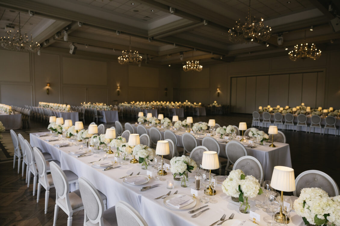 The supper-club reception room with checkerboard floor and white florals.