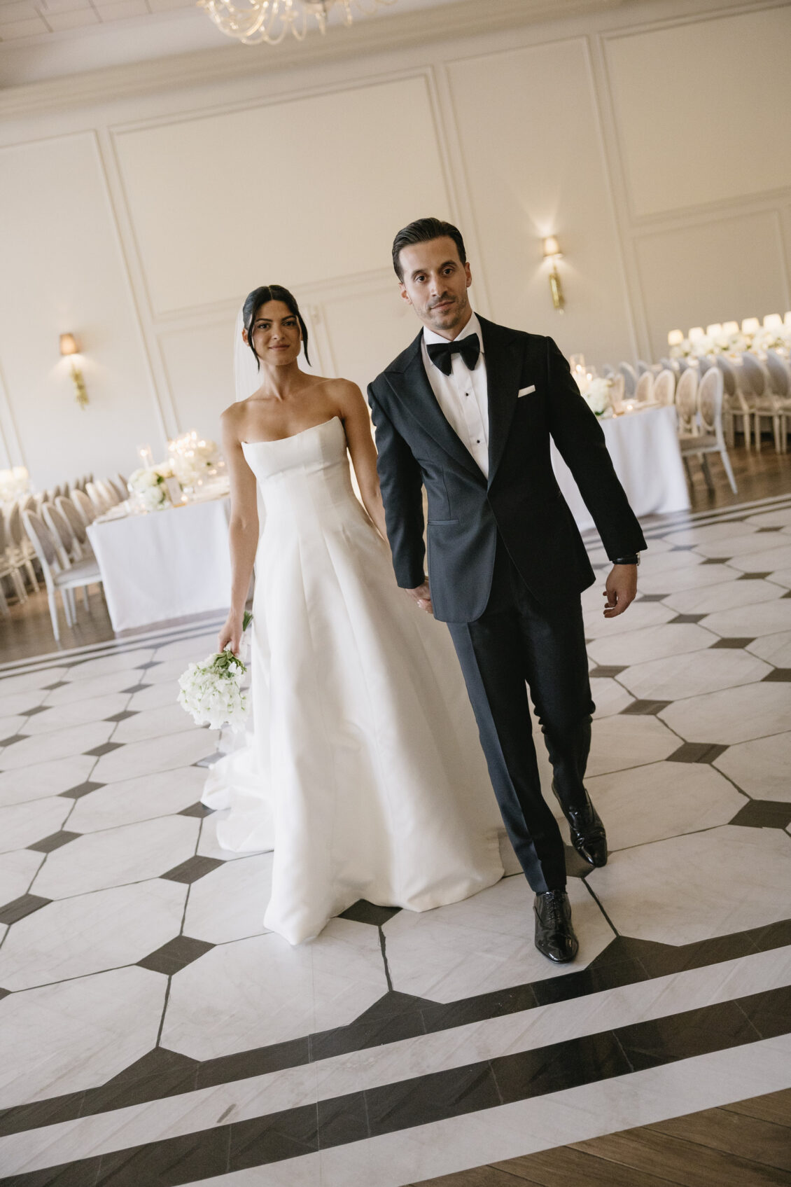 Erica and Anthony walk through their finished reception room.