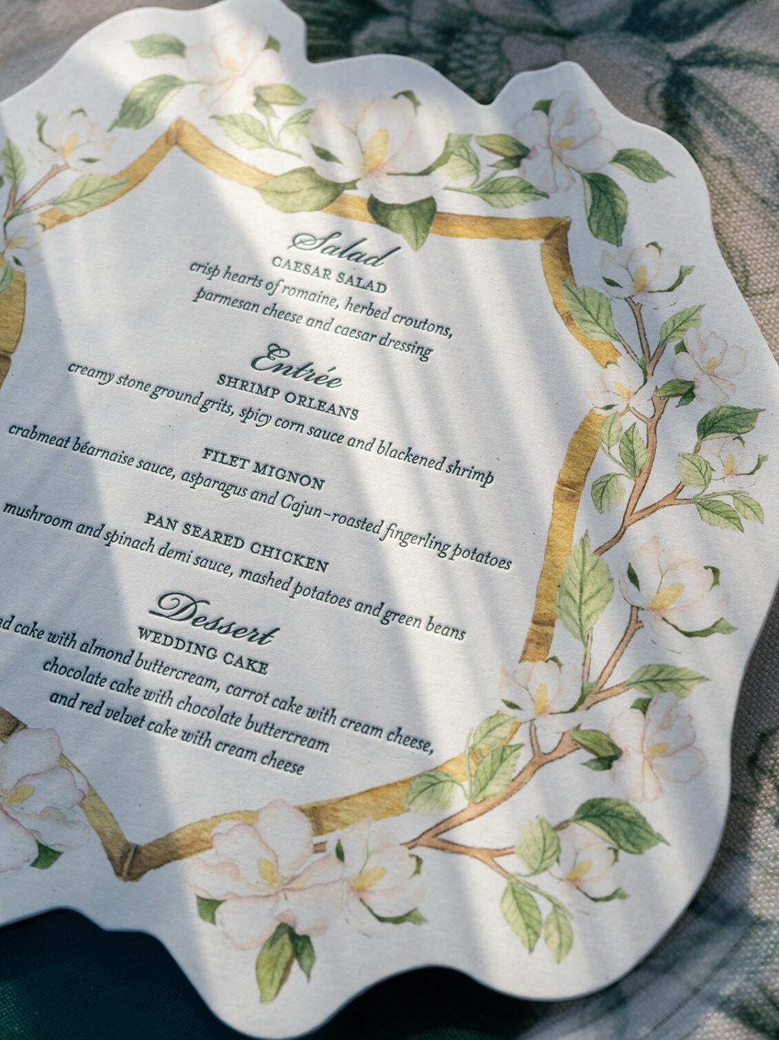 Magnolia florals, checkerboard details, and reception design at White House Biloxi.