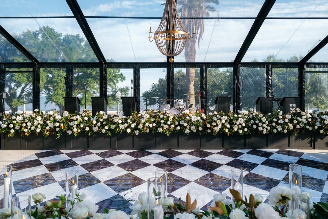 Magnolia florals, checkerboard details, and reception design at White House Biloxi.