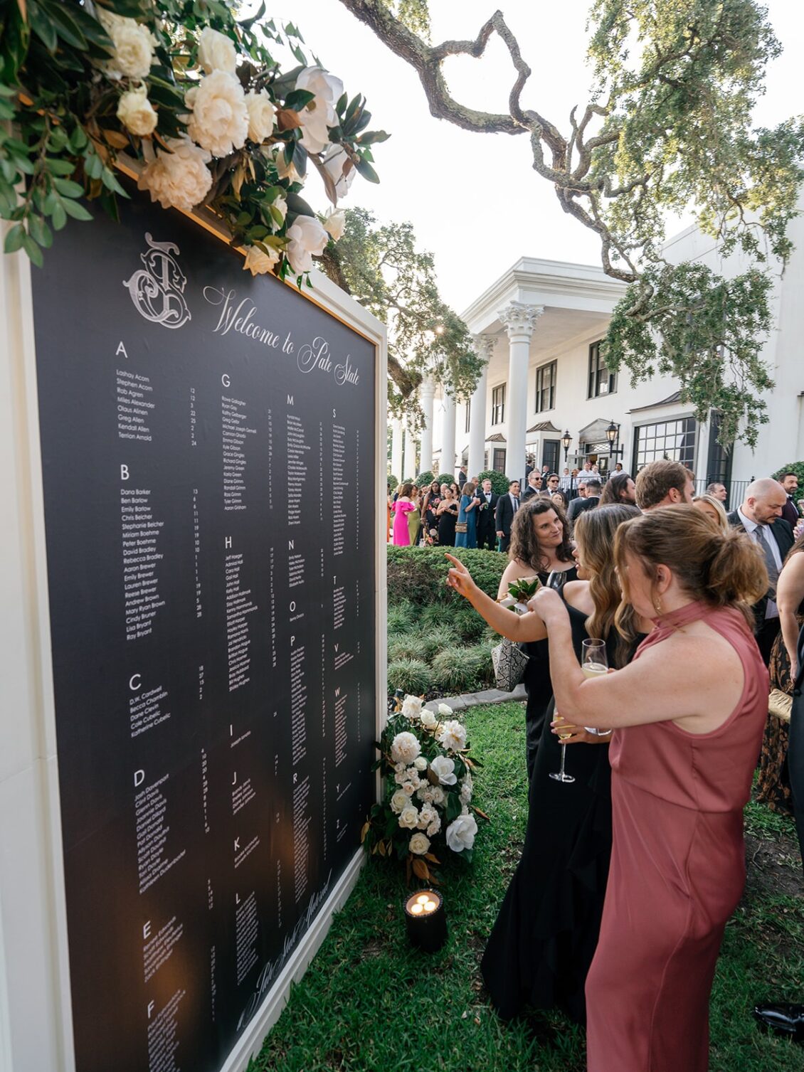Magnolia florals, checkerboard details, and reception design at White House Biloxi.