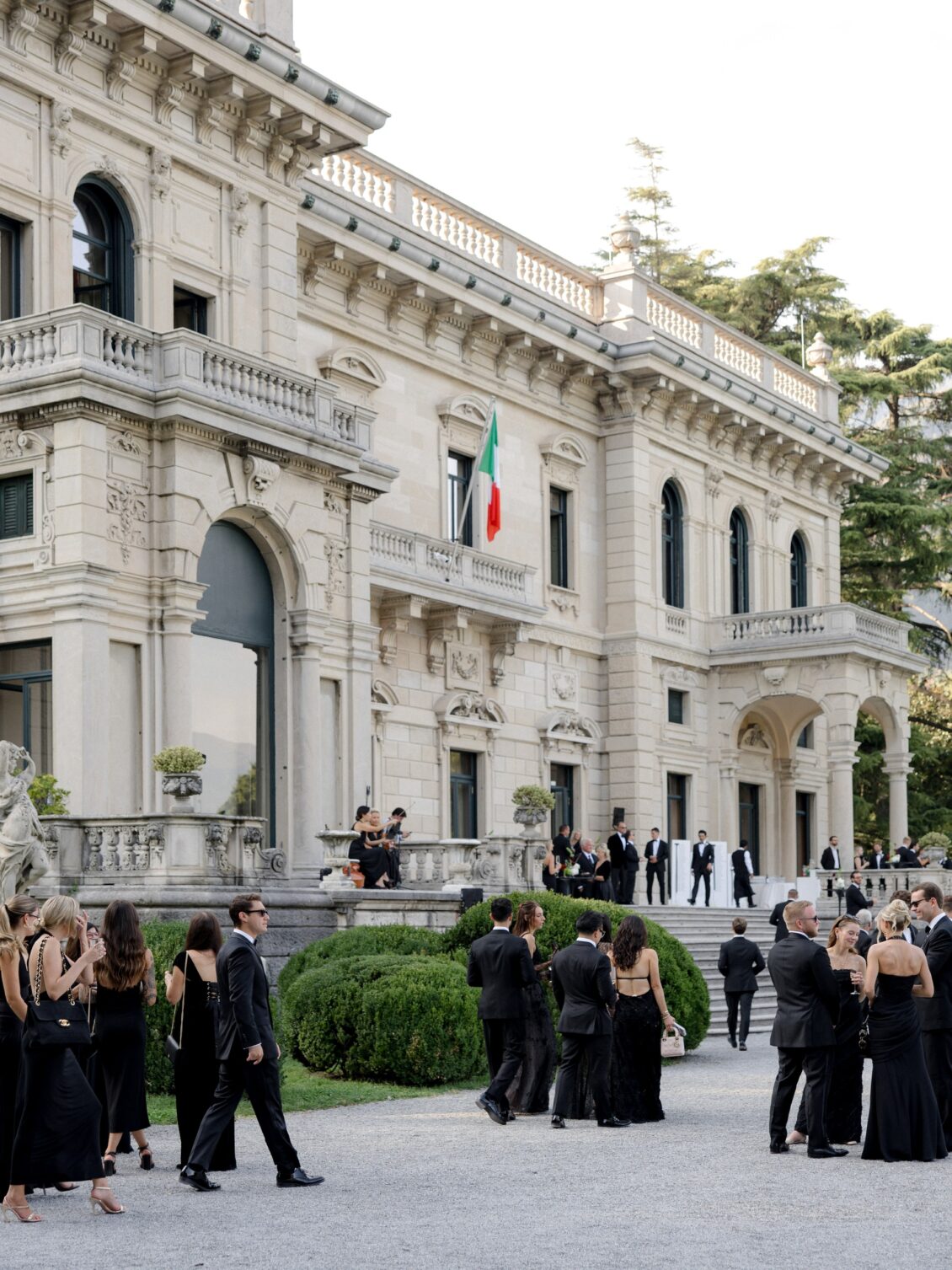 Wedding guests gather outside Villa Erba before the ceremony.