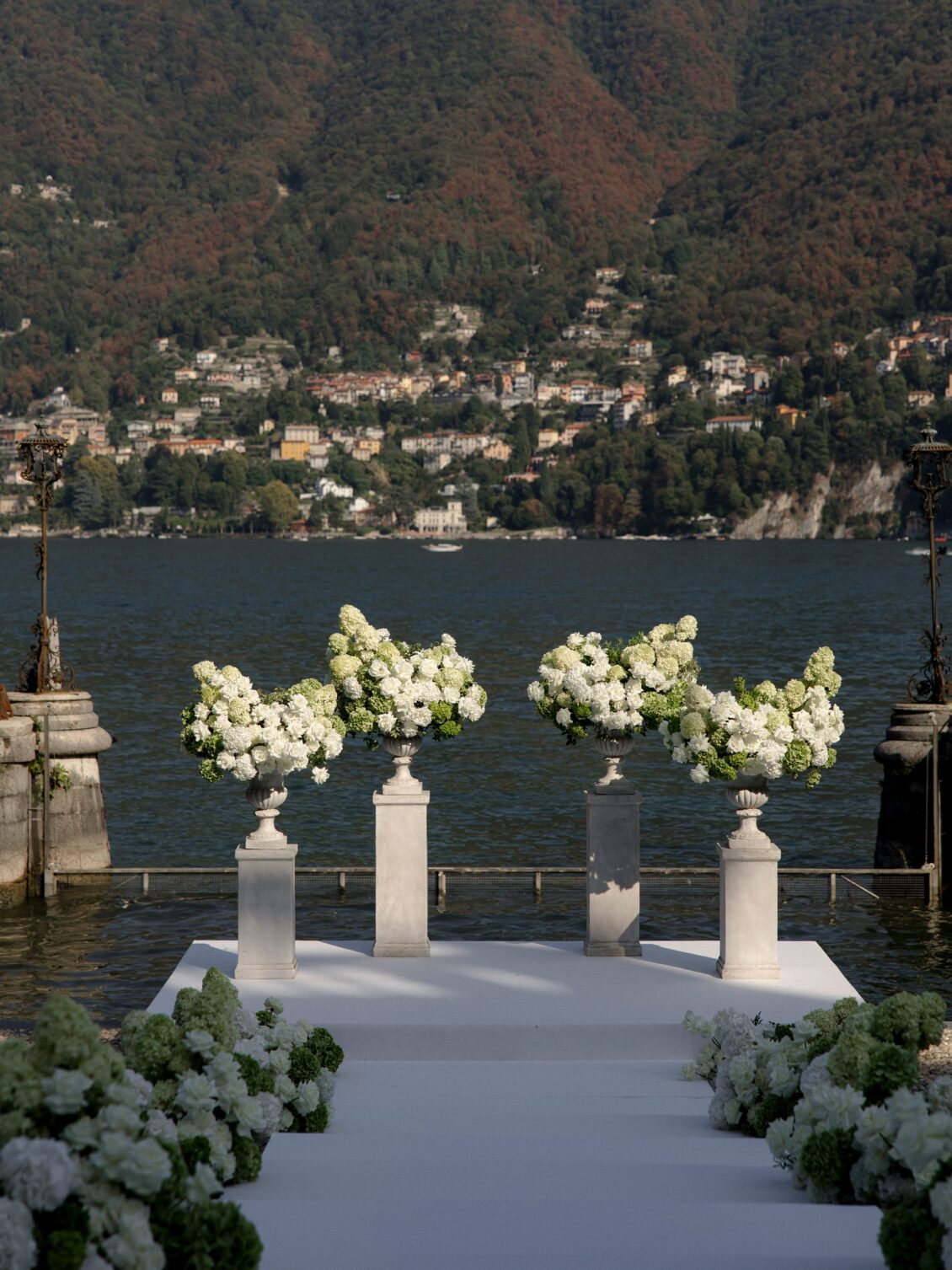 White floral ceremony platform overlooking Lake Como.