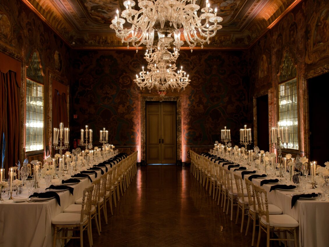 Symmetrical view of banquet tables and chandeliers at Villa Erba.