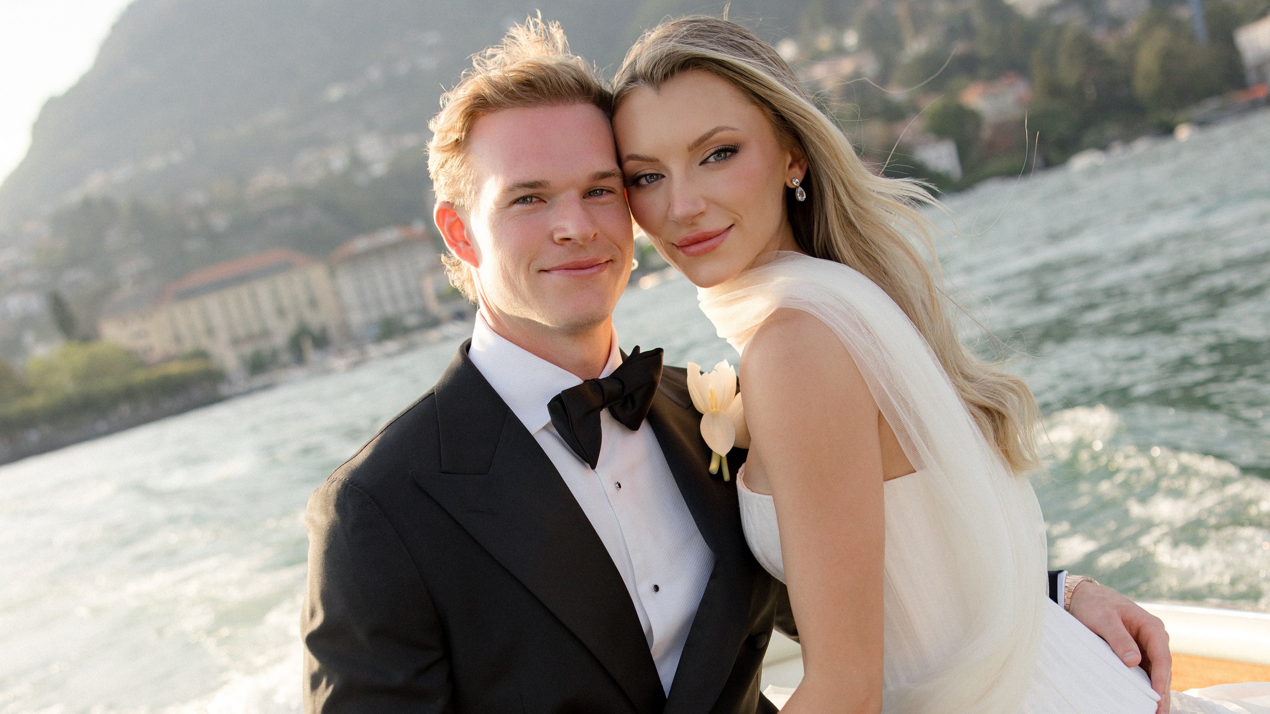 Lindsay and Michael together on a turquoise boat on Lake Como.