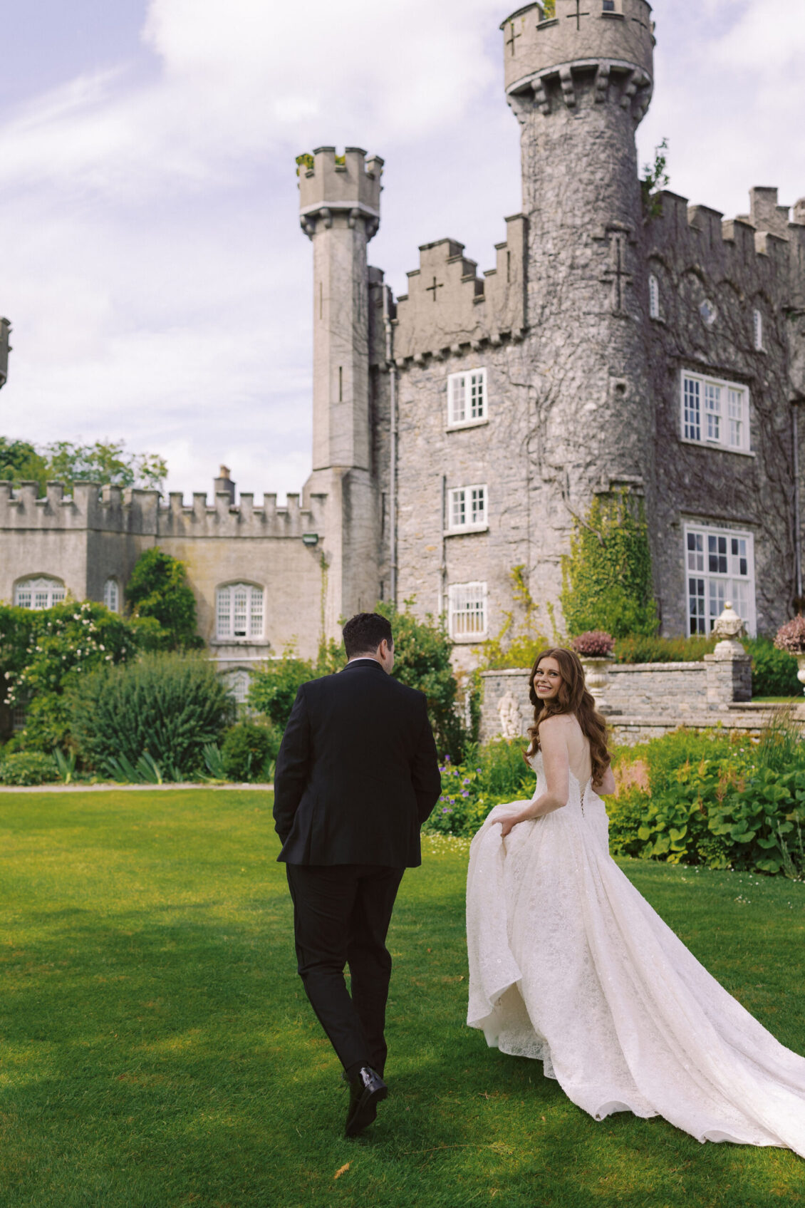 Newlyweds walking toward Luttrellstown Castle Resort