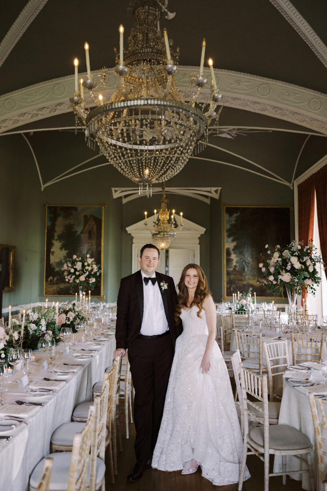 Newlyweds in a chandelier-lit reception room at Luttrellstown Castle Resort