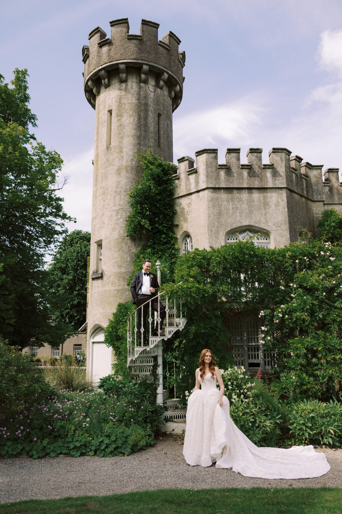 Bride and groom beside an ivy-covered tower at Luttrellstown Castle Resort