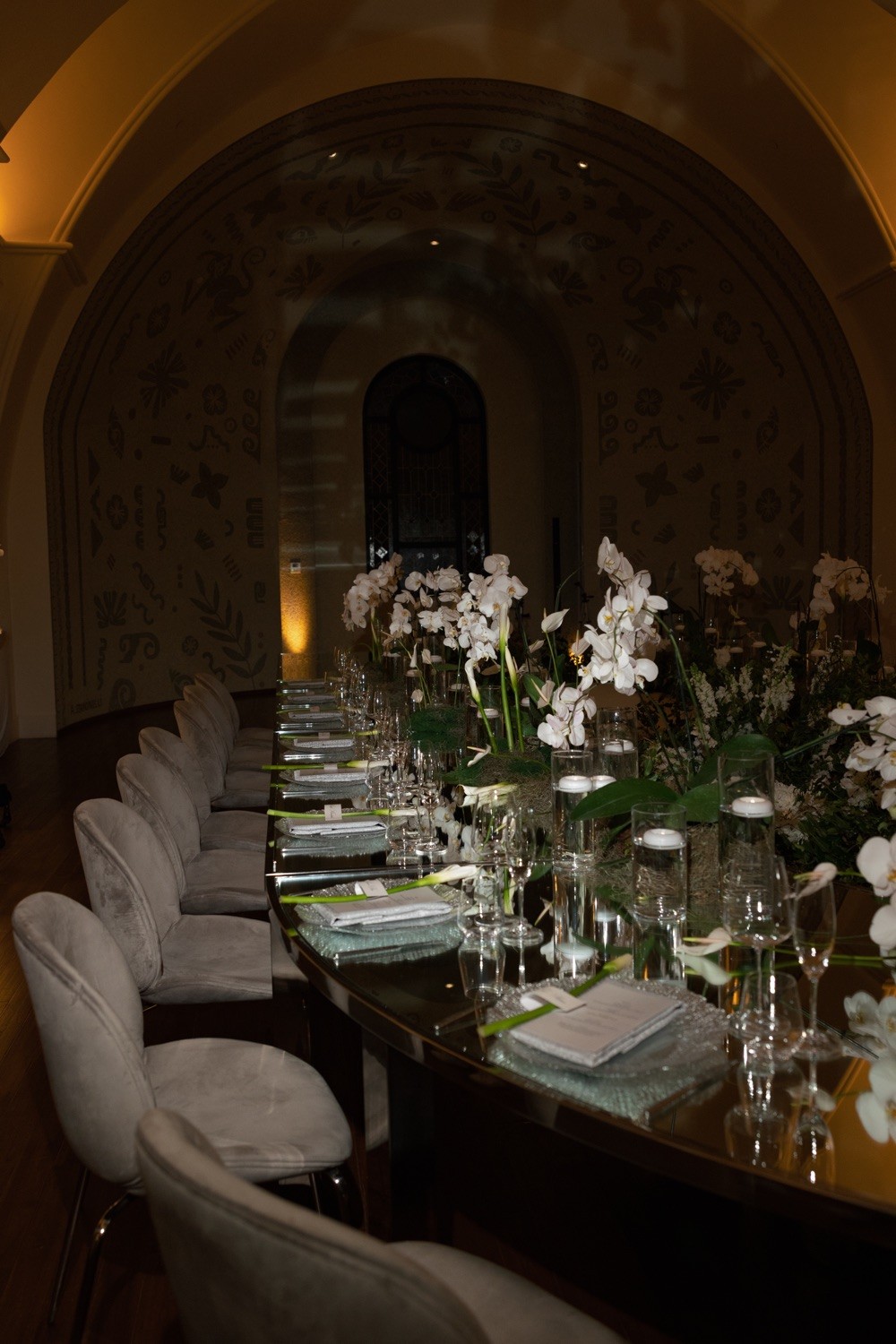 Long banquet table inside an arched dining room at Nekajui