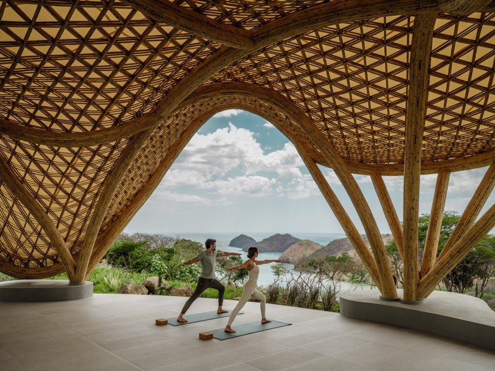 Guided movement session beneath a bamboo pavilion at Nekajui
