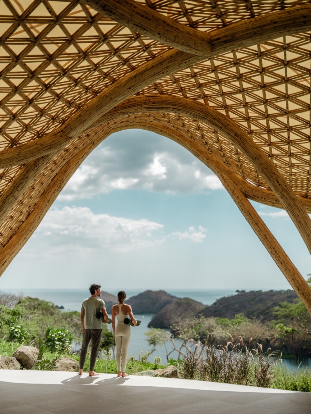 Couple looking over the Pacific from a bamboo pavilion at Nekajui