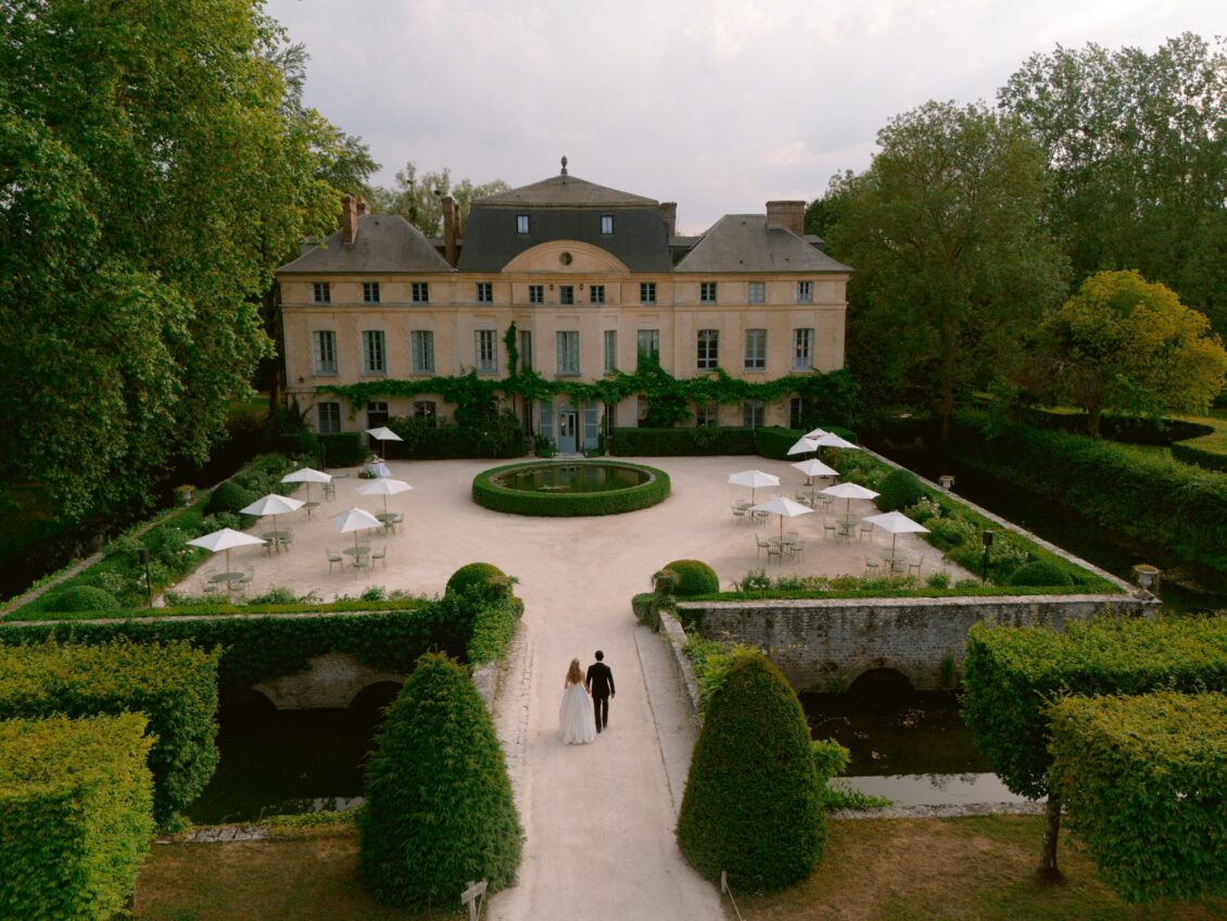 Aerial view of Lamya and Sam on the parterre path leading to the château at Domaine de Primard