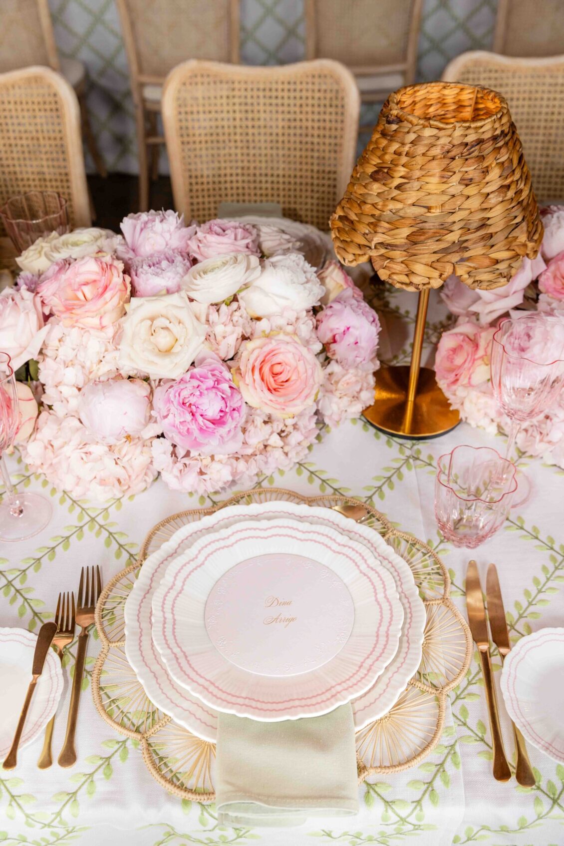 Pink china with gold flatware at a bridal shower place setting
