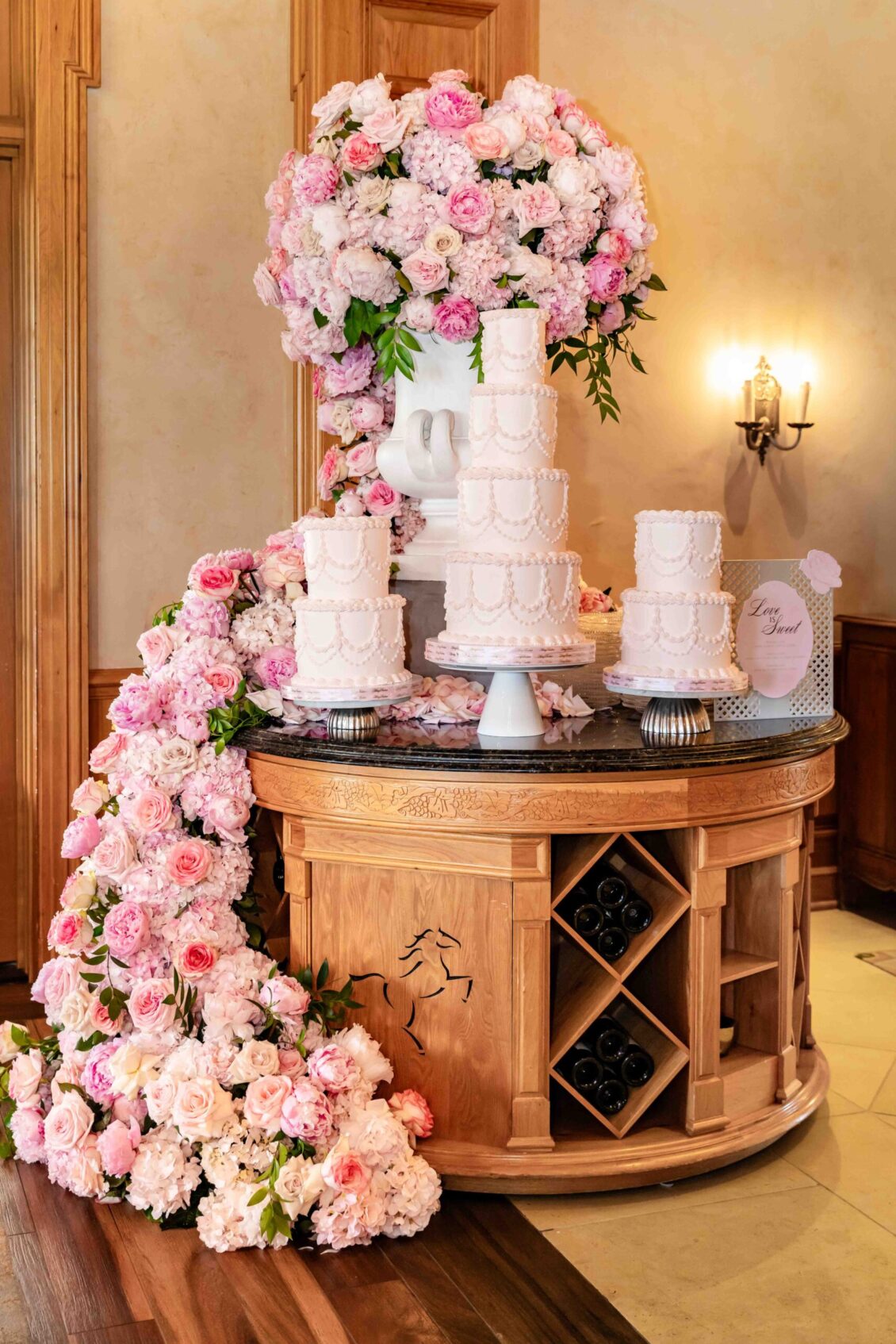 Cascading pink floral cake display in the dining room