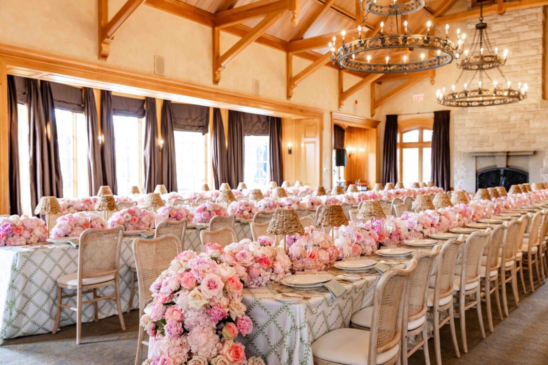 Grand dining room filled with cascading pink floral tablescapes