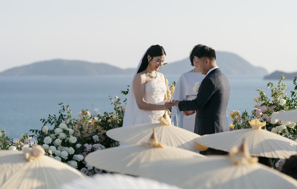 Vivian and Josen’s romantic destination wedding at Trisara Phuket — couple exchanging rings or holding hands