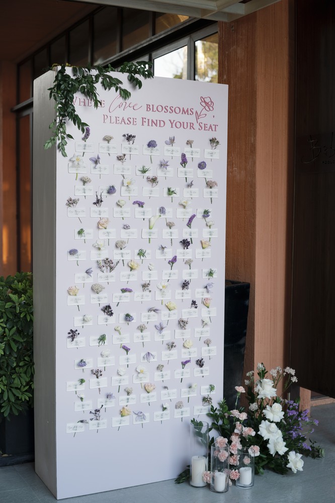 Vivian and Josen’s romantic destination wedding at Trisara Phuket — full botanical seating and escort-card display